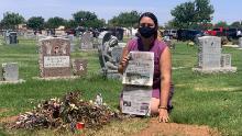 Kristin Urquiza hold her father&#39;s obituary over his grave.