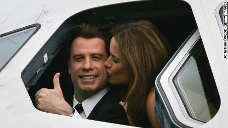 John Travolta is kissed by his wife actress Kelly Preston as they sit in the cockpit of an Airbus A380 at Brisbane International Airport on November 15, 2005.