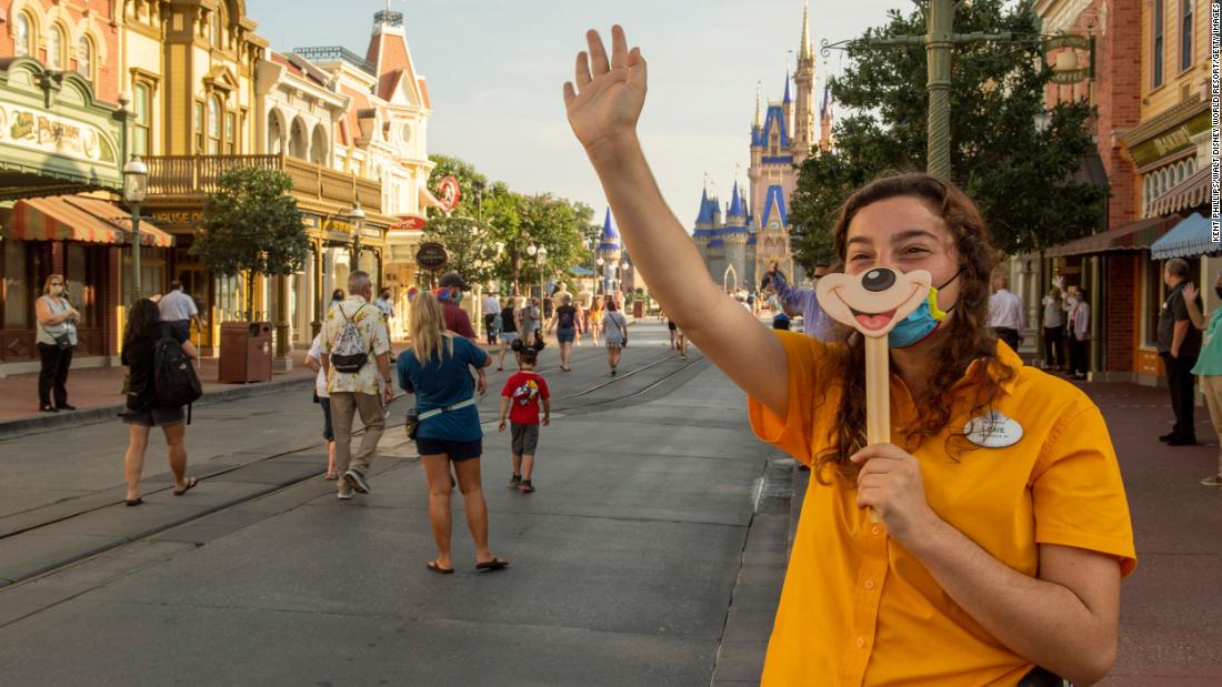 In this handout photo provided by the Walt Disney World Resort, a worker welcomes guests to the Magic Kingdom Park in Lake Buena Vista, Florida, on July 11. &lt;a href=&quot;http://www.cnn.com/travel/article/disney-masks-covid-rides-trnd/index.html&quot; target=&quot;_blank&quot;&gt;The park&#39;s reopening&lt;/a&gt; came the same weekend that Florida reached a record high for single-day case count increase.