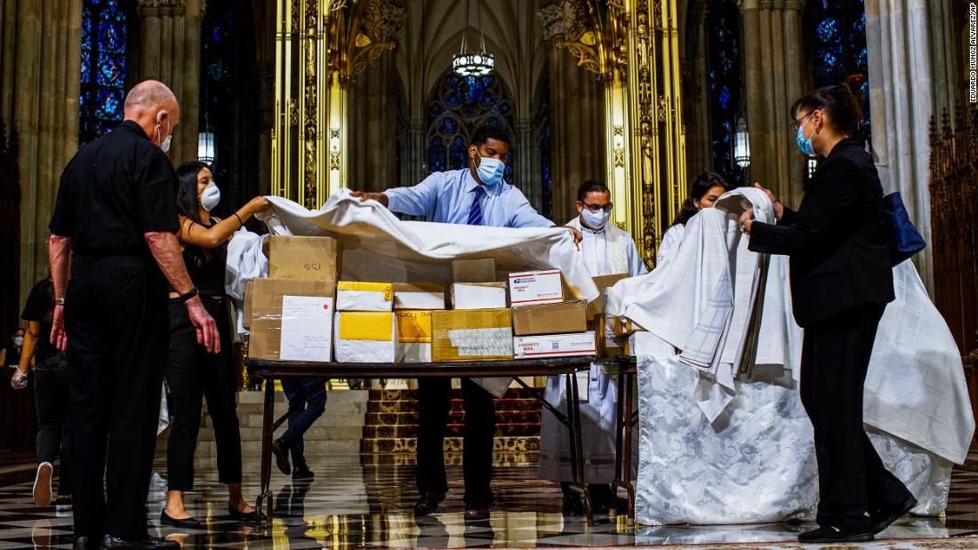 The boxed cremated remains of Mexicans who died from Covid-19 are covered before a service at  St. Patrick&#39;s Cathedral in New York on July 11. The ashes were blessed before they were repatriated to Mexico.