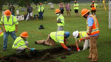 Workers and researchers dig at Oaklawn Cemetery in Tulsa during a test excavation in the search for possible mass graves from the 1921 Tulsa race massacre. 