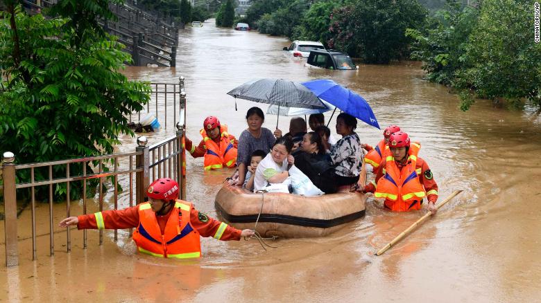 Rescuers evacuate residents on a raft through flood waters in Jiujiang in central China&#39;s Jiangxi province on July 8.