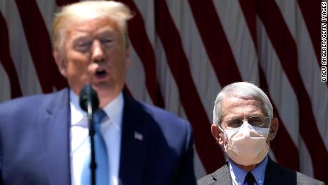 U.S. President Donald Trump is flanked by Dr. Anthony Fauci, director of the National Institute of Allergy and Infectious Diseases while speaking about coronavirus vaccine development in the Rose Garden of the White House on May 15, 2020 in Washington, DC. 