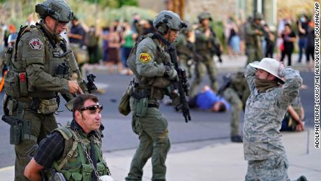 Albuquerque police detain members of the New Mexico Civil Guard last month in Albuquerque.