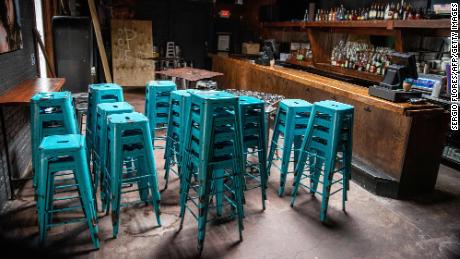 Chairs sit stacked inside a closed bar in Austin, Texas.