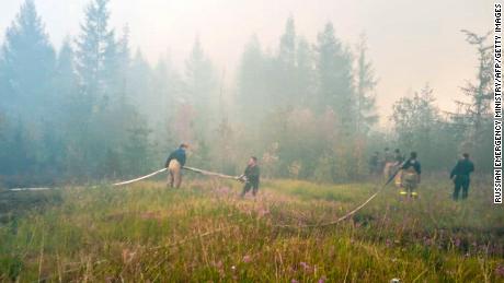 Firefighters battle to extinguish forest fires near the village of Batagay, Sakha Republic in northeastern Russia.