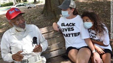 James Meredith sits on a park bench in Jackson with Keri Herrington and Eriyuanna Woods last month.