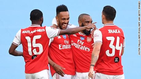 Arsenal&#39;s Gabonese striker Pierre-Emerick Aubameyang (second left) is surrounded by teammates after scoring the opening goal of the FA Cup semifinal against Manchester City at Wembley. 