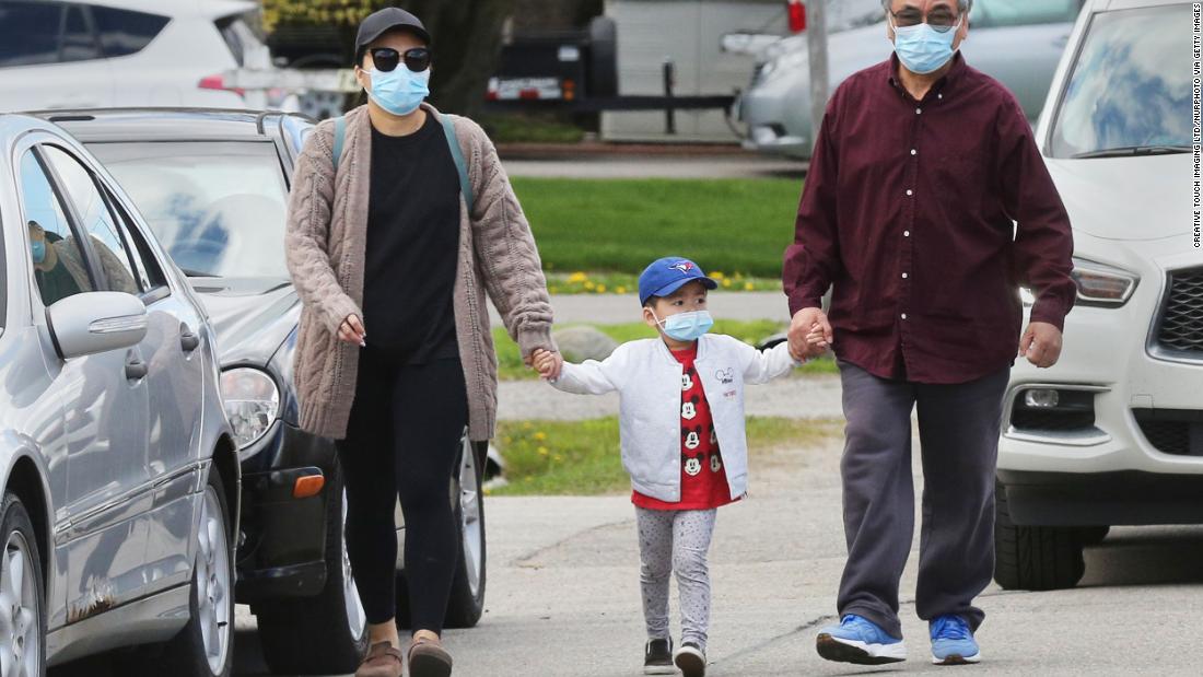 &lt;strong&gt;Canada: A f&lt;/strong&gt;amily wear face masks as they walk in Richmond Hill, Ontario, on May 16.