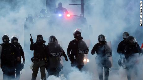 Police officers launch tear gas canisters at protesters in Detroit during a demonstration over the death of George Floyd in Minneapolis on Sunday, May 31, 2020.