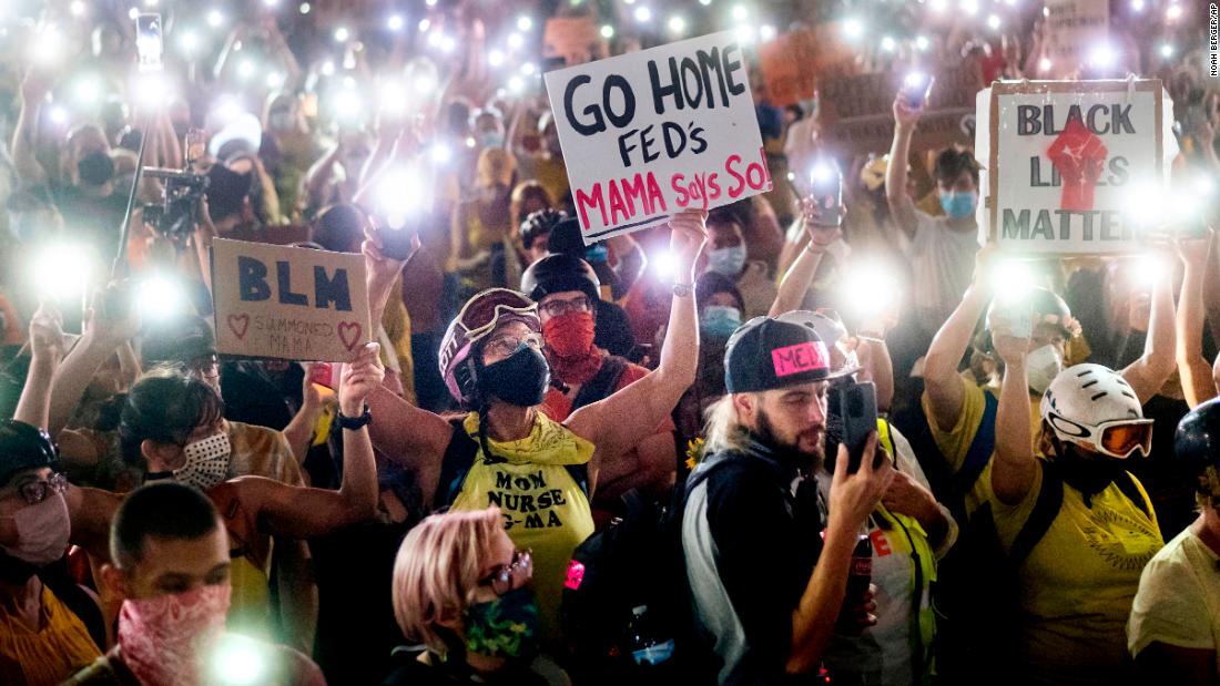 Hundreds of people shine light from their cell phones during a protest on July 20.