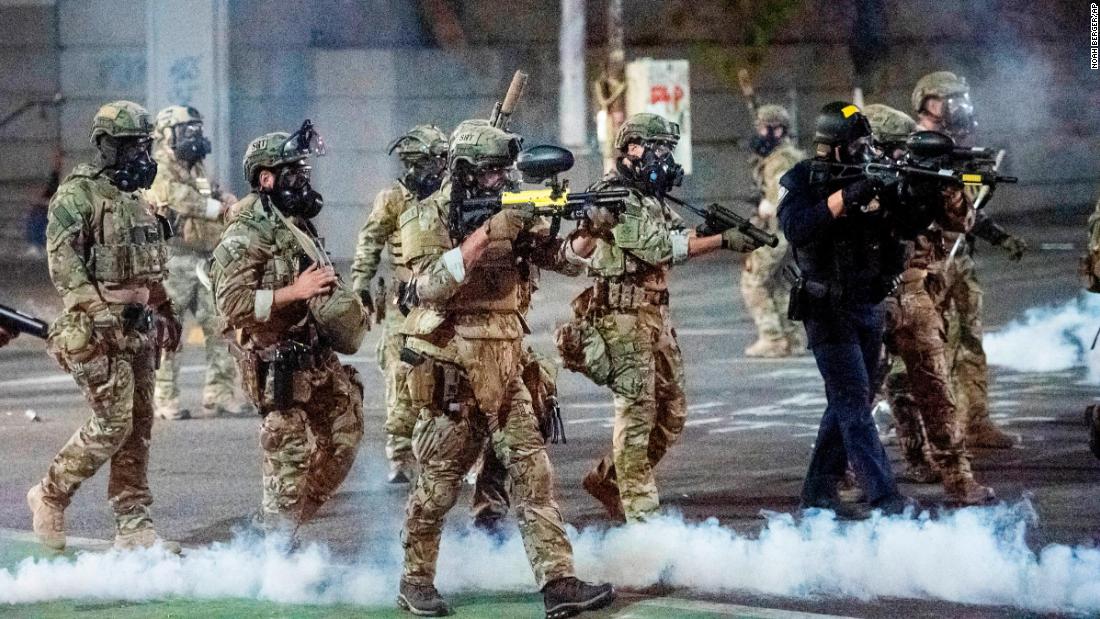 Federal agents use crowd-control munitions to disperse protesters at the courthouse on July 20. Officers used tear gas and projectiles to move the crowd after some protesters tore down a fence fronting the courthouse.