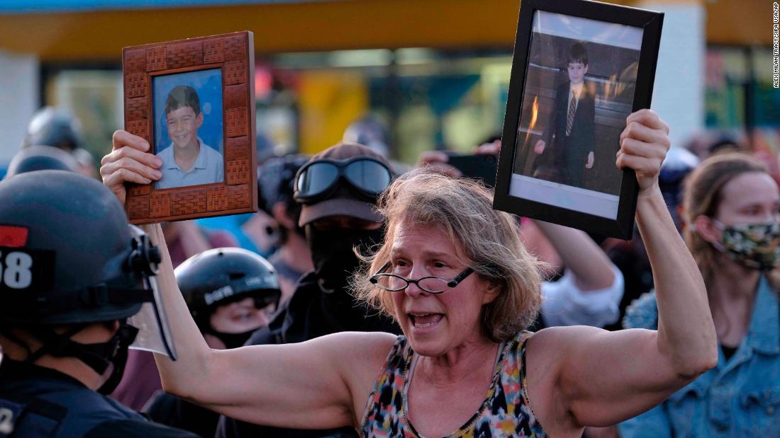 The mother of injured protester Donovan LaBella, who was shot in the head with an impact munition by federal officers, pleads with police during a protest outside the Portland Police Association building on July 13.