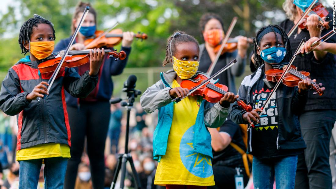 People play instruments on July 3 as they mourn the death of Elijah McClain, a 23-year-old Black man &lt;a href=&quot;https://www.cnn.com/2020/07/03/us/officers-in-photos-near-elijah-mcclain-memorial-fired/index.html&quot; target=&quot;_blank&quot;&gt;who was killed by police in Colorado&lt;/a&gt; last year.