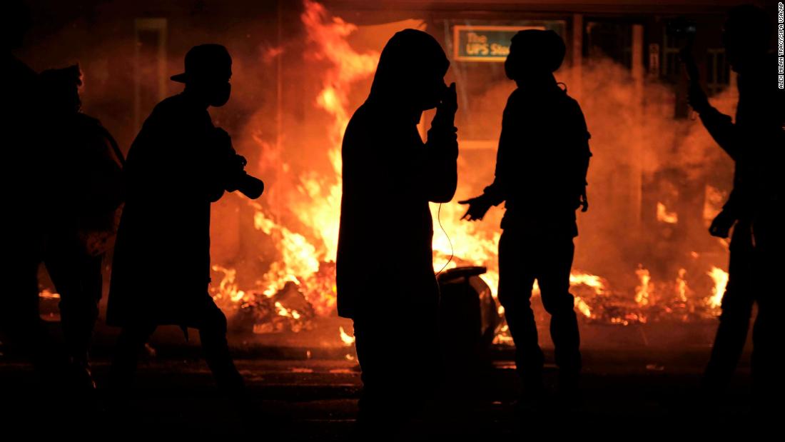 Trash cans burn during demonstrations on June 15.