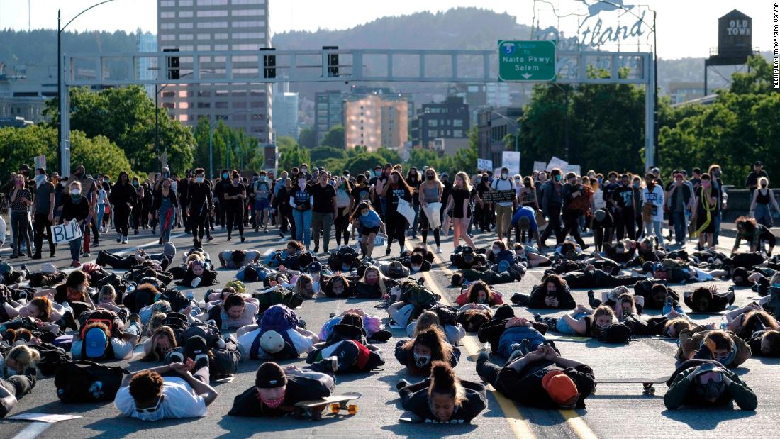 Protesters lie down on the Burnside Bridge during a moment of silence on June 1.
