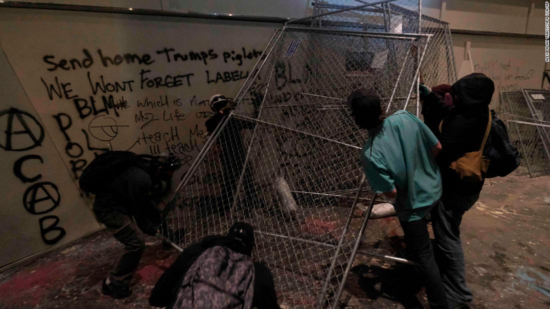 Protesters move fencing in front of a federal courthouse on July 18.