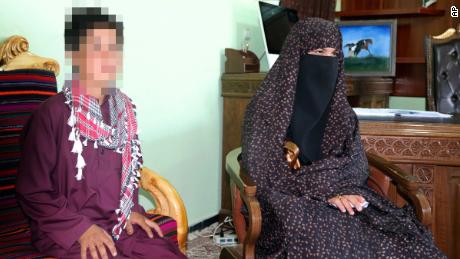 CNN has blurred part of this image to protect the identity of the subject. Qhamar and Habibullah Gul pose for photographs in the governor&#39;s office in Feroz Koh, the provincial capital of Ghor province, in western Afghanistan, Tuesday, July 21, 2020. 