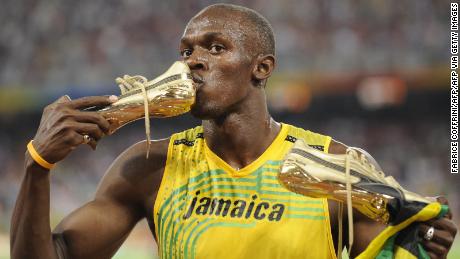 Jamaica's Usain Bolt kisses his shoe after winning the men's 100m final at the National stadium as part of the 2008 Beijing Olympic Games on August 16, 2008.