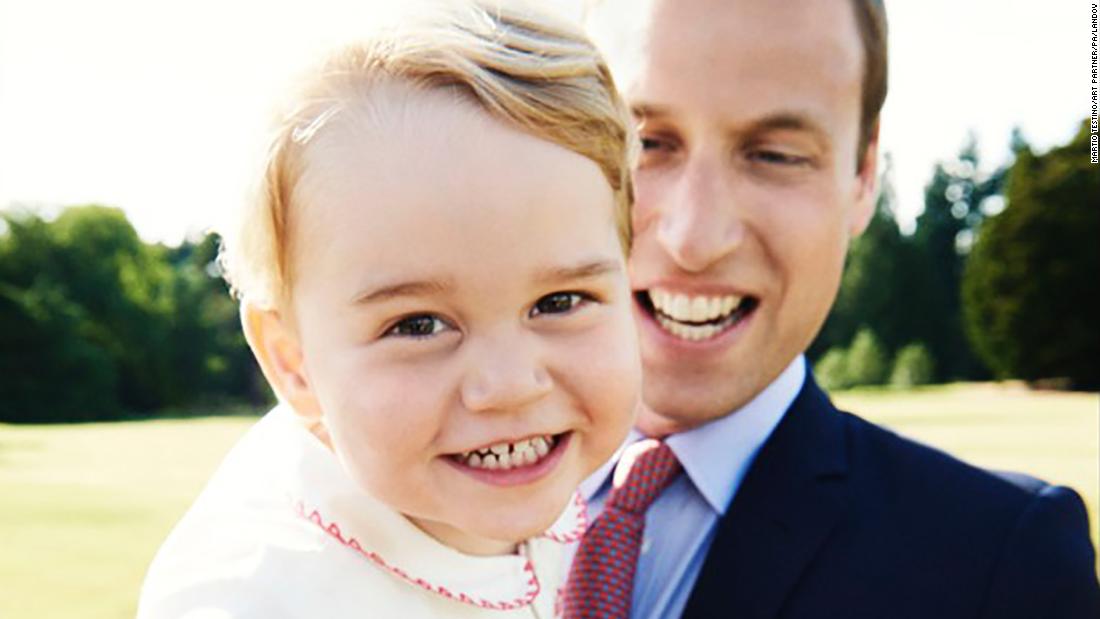 Prince George is held by his father a day before his second birthday in July 2015.