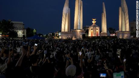 Protesters hold up their mobile phones during an anti-government demonstration at Democracy Monument in Bangkok on July 18.
