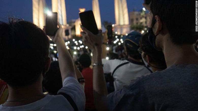 Protesters hold up their mobile phones during an anti-government demonstration at Democracy Monument in Bangkok on July 18.