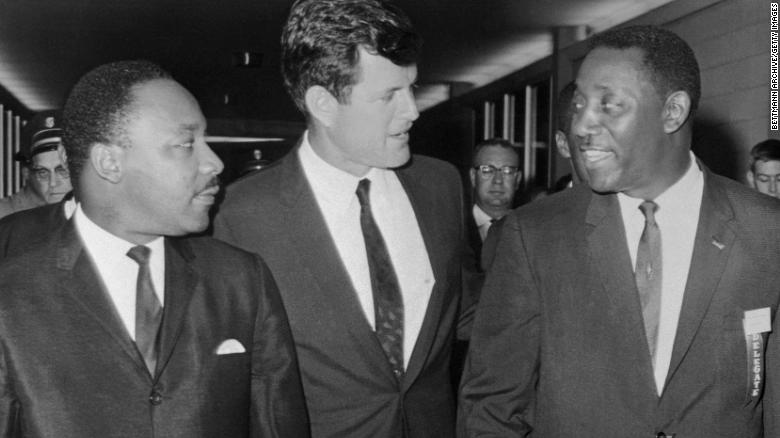 In this undated image, Sen. Ted Kennedy talks with the Rev. Martin Luther King Jr., left, and Charles Evers, then the Mississippi NAACP field director, in Jackson.