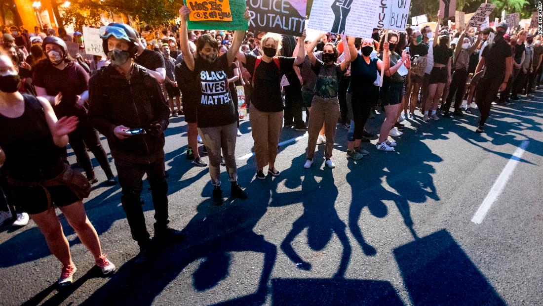 Protesters hold signs on July 21.