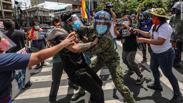 Police clash with protesters during a LGBTQ pride march in Manila, Philippines, on June 26, 2020. Demonstrators were also protesting the country&#39;s new anti-terror law.