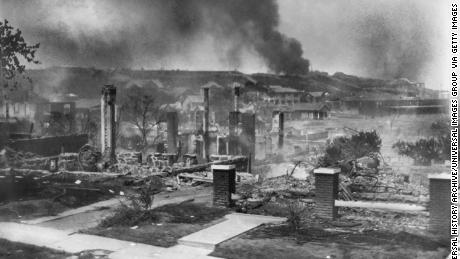 The homes of African Americans smolder following the Tulsa race riots in June 1921.