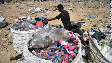 A garbage collector gathering recyclable plastic at the Ban Tarn landfill site in the Thai province of Chiang Mai.