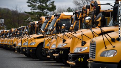 About 100 school buses are parked at the Arlington County Bus Depot,  in response to the novel coronavirus, COVID-19 outbreak on March 31, 2020 in Arlington, Virginia. - Forty-seven states and the District of Columbia have decided to close schools in response to the coronavirus pandemic, affecting nearly 55 million students and seven US states have closed school for the remainder of the year, as the coronavirus outbreak continues to spread across the country. (Photo by Olivier DOULIERY / AFP) (Photo by OLIVIER DOULIERY/AFP via Getty Images)