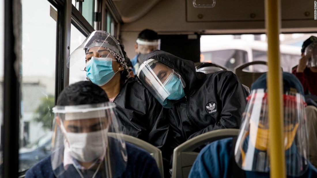 Commuters wear face masks and face shields while traveling on a public bus in Lima, Peru, on July 22. Peru has mandated masks and shields on public transportation.