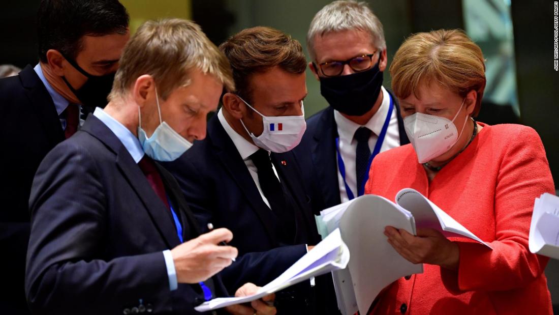 Merkel and other world leaders look over documents during a European Union summit in Brussels, Belgium, in July 2020. Leaders agreed to create a &lt;a href=&quot;https://www.cnn.com/2020/07/21/economy/eu-stimulus-coronavirus/index.html&quot; target=&quot;_blank&quot;&gt;&amp;euro;750 billion ($858 billion) recovery fund&lt;/a&gt; to rebuild EU economies ravaged by the coronavirus crisis.