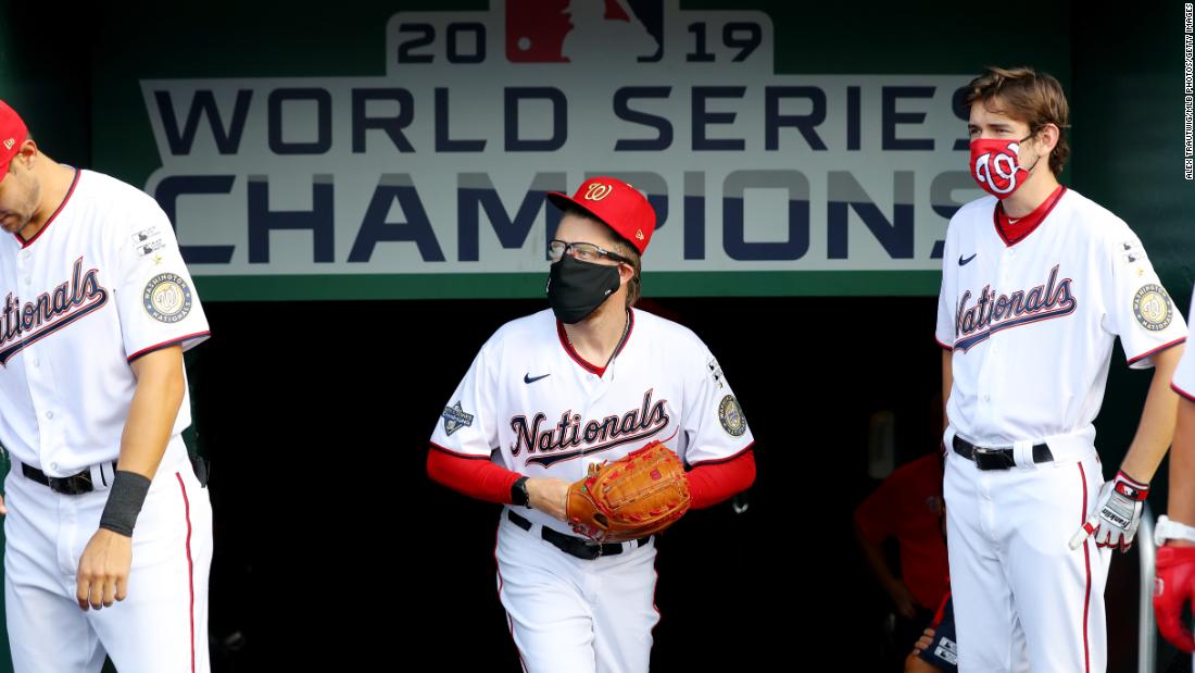 Washington reliever Sean Doolittle, center, wears a face mask in the dugout before Thursday&#39;s game.