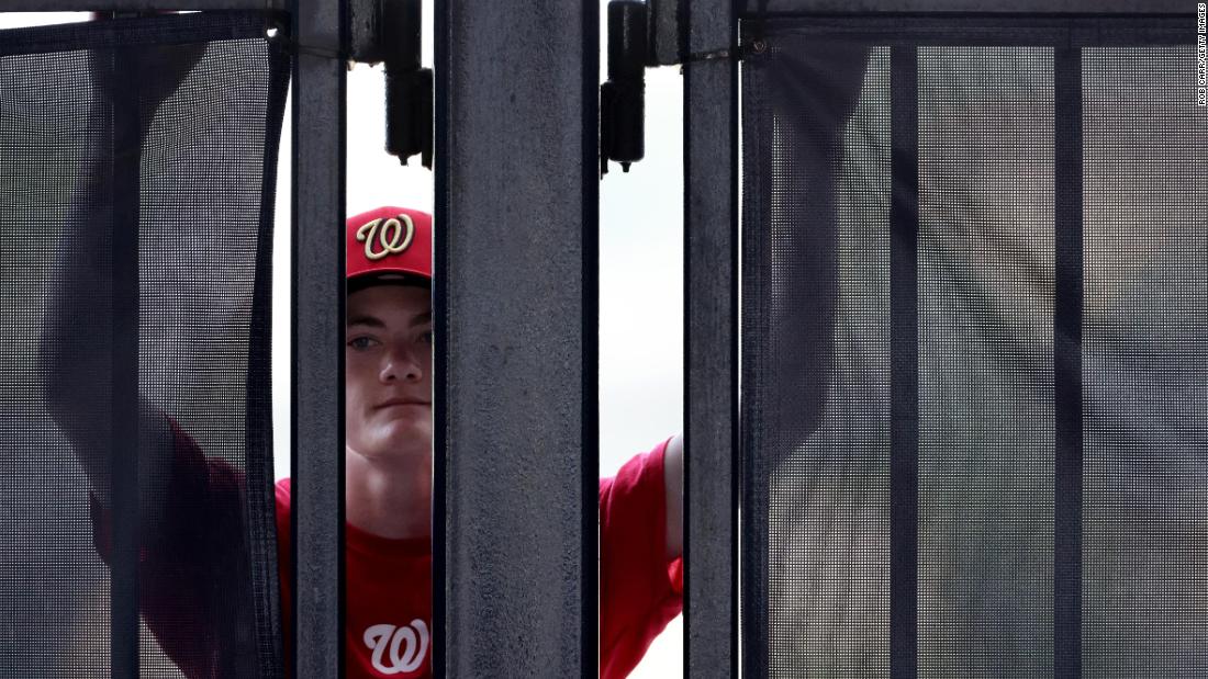 A Nationals fan looks through a stadium gate on Thursday.