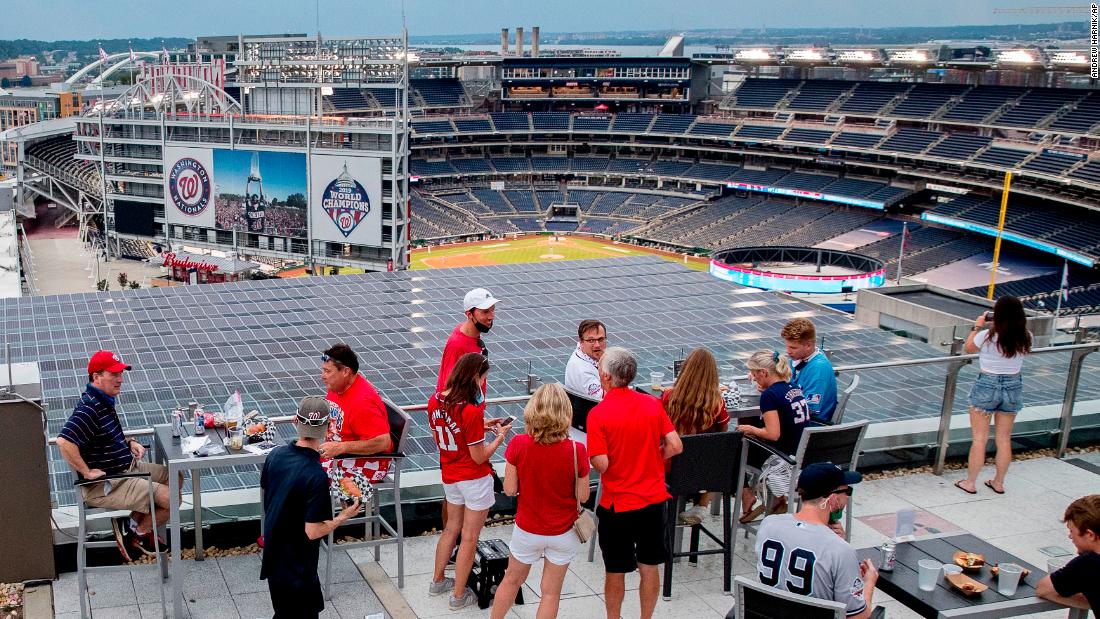 People watch the opener from a rooftop bar overlooking Nationals Park.