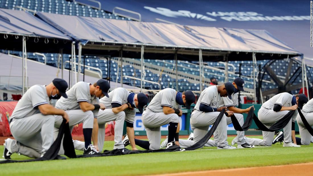 The Yankees kneel for a moment of silence before standing for the National Anthem on Thursday. The Nationals also took a knee to show their support for the Black Lives Matter movement. The initials BLM were on the pitcher&#39;s mound for the game.