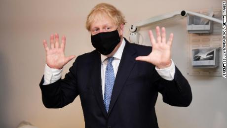 Boris Johnson wears a face mask as he visits a medical center in London on Friday.