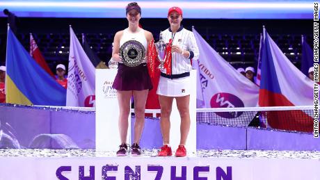 Champion Ashleigh Barty and Elina Svitolina pose with their trophies after the WTA Finals in 2019. 