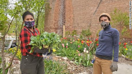 Soul Fire Farm assistant program manager Kiani Conley-Wilson, Left, and Z Estime build a garden bed for a community member as part of the  Soul Fire in the City project. 