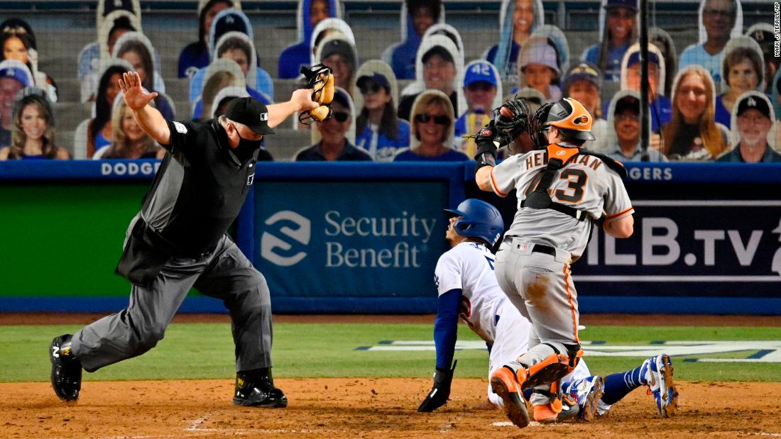 Umpire Bill Miller calls Mookie Betts safe at home plate, scoring a run for the Dodgers on Thursday.