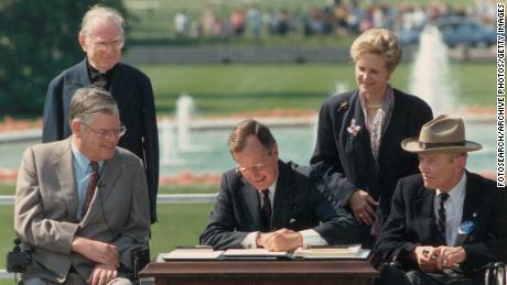 George Bush signs the Americans with Disabilities Act of 1990.