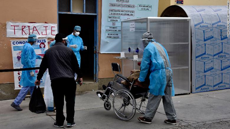 Health workers bring a suspected coronavirus patient into a hospital in La Paz on July 23, 2020. 