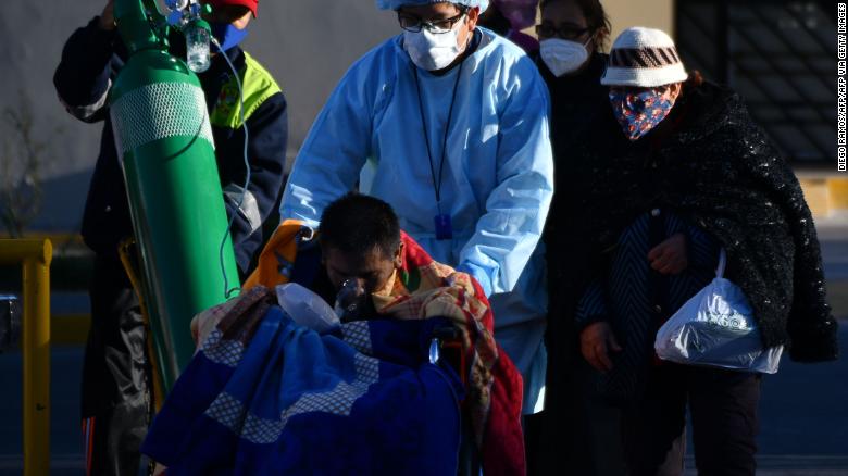 A nurse helps a Covid-19 patient outside a hospital in the city of Arequipa, Peru, on July 23, 2020.