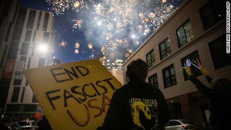 Protesters light fireworks in the middle of downtown Oakland during a protest on Saturday, July 25, 2020, in Oakland, California.