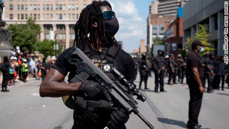 Members of the &quot;Not F**ing Around Coalition&quot; (NFAC), an all black militia, march during a rally to protest the killing of Breonna Taylor, in Louisville, Kentucky on July 25, 2020. 