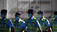 Policemen march in front of the US consulate in Chengdu, southwestern China's Sichuan province, on July 26.