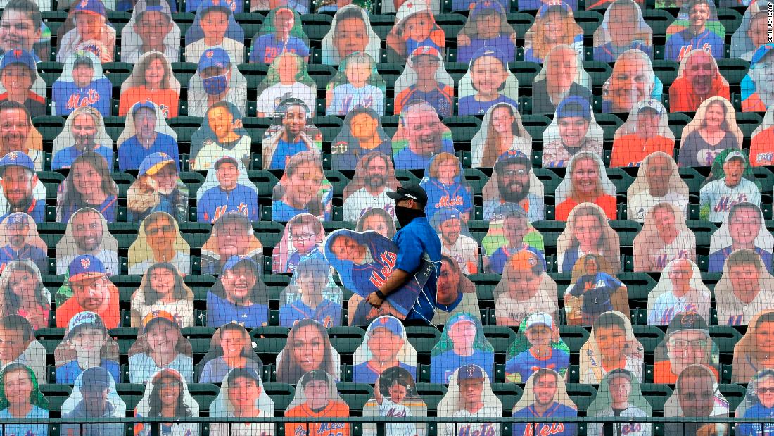 A New York Mets employee places fan cutouts before the team&#39;s opener on Friday, July 24.