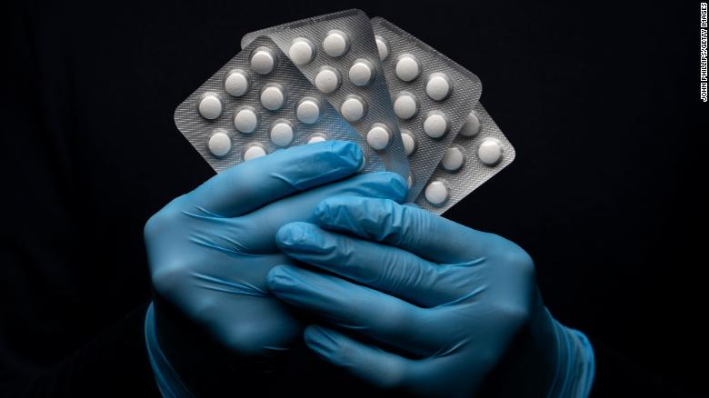 In this photo illustration a pack of Hydroxychloroquine Sulfate medication is held up.